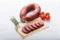 Food, horse meat and delicious concept - sliced sausage with tomato and pepper Royalty Free Stock Photo