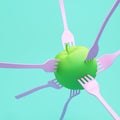 Food idea concept, fruit green Apple impaled on pink forks on bl