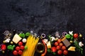 Food ingredients for italian pasta, spaghetti on black stone slate background. Copy space of your text Royalty Free Stock Photo