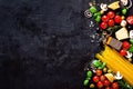 Food ingredients for italian pasta, spaghetti on black stone slate background. Copy space of your text Royalty Free Stock Photo