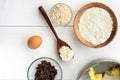 Food ingredients and kitchen utensils for cooking oat cookies on white wooden background. Top flat view Royalty Free Stock Photo