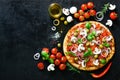 Food ingredients and spices for cooking mushrooms, tomatoes, cheese, onion, oil, pepper, salt, basil, olive and Royalty Free Stock Photo