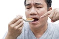 Food Insect: Man hand holding spoon eating Bamboo Worm insect or Bamboo Caterpillar deep-fried as food on white background, is Royalty Free Stock Photo