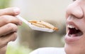 Food Insects: Man eating bamboo worm insect on spoon. Bamboo Caterpillar is good source of protein edible and delicious for future Royalty Free Stock Photo