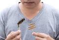 Food Insects: Man eating Bamboo Worms and Crickets insect deep-fried crispy for eat as food snack, it is good source of protein Royalty Free Stock Photo