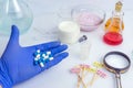 Food inspector holds pills in the palm of his hand. Laboratory Food Quality Control. Check for additives in yogurt and Royalty Free Stock Photo