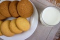 Food, junk-food, culinary, baking and eating concept - close up oatmeal cookies and milk glass Royalty Free Stock Photo