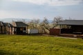 Food kiosk near castle Valecov, green lawn in sunny day, pastoral landscape of Bohemian Paradise, wooden table and benches, Bosen