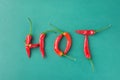 Food Lettering Typography. Word Hot Made from Red Spicy Chili Peppers on Green Background. Mexican Italian Spanish Greek Cuisine Royalty Free Stock Photo