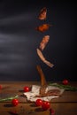 Food levitation. Flying meat jerky in front of dark background