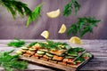 Food levitation, red salmon sandwiches on diet bread with lemons, fresh dill and cucumbers, flying foods, fashion photo, colorful