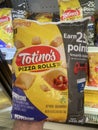 Food Lion grocery store hand holding Totinos Pizza Rolls large size
