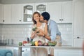 Food, love and elderly couple in kitchen, kiss and hug while prepare meal, bond and smile in their home. Love, cooking