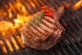 Food meat - beef steak on bbq barbecue grill with flame Royalty Free Stock Photo