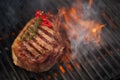 Food meat - beef steak on bbq barbecue grill with flame Royalty Free Stock Photo