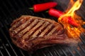 Food meat - beef steak on bbq barbecue grill with flame Royalty Free Stock Photo