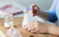 Hands with bottle and scoop making formula milk Royalty Free Stock Photo