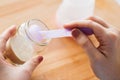 Hands with jar and scoop making formula milk Royalty Free Stock Photo