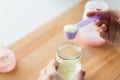 Hands with jar and scoop making formula milk Royalty Free Stock Photo