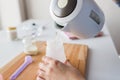 Hands with kettle and bottle making baby milk Royalty Free Stock Photo