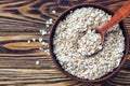 Food. Oatmeal on the table. Dry rolled oat flakes oatmeal in brown bowl on old wooden table. Royalty Free Stock Photo