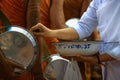 Food offering by buddhist Thai female to the monk