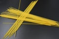 Long dry vermicelli, Italian pasta spaghetti from hard wheat varieties in packs on an interesting black background