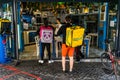 Food Panda and Glovo food delivery courier waiting to pick up order in Old Town of Bucharest, Romania, 2020. Food deliveries by Royalty Free Stock Photo