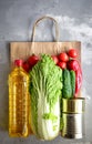 Food in a paper bag. Food donation or food delivery concept. Free space for text. Oil, bread, cabbage, salad, vegetables Royalty Free Stock Photo