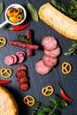Food party background 3kind of meat Saucisson french salami, olive, prezels and homemade bread on black slate stone Royalty Free Stock Photo
