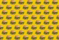 food pattern of repeated hamburgers or burgers or cheeseburgers on yellow background