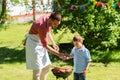 Father and son cooking meat on barbecue grill Royalty Free Stock Photo