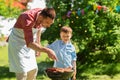 Father and son cooking meat on barbecue grill Royalty Free Stock Photo