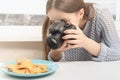 Food photo. Girl photographer takes nachos chips on a plate