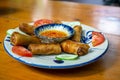 Food Photo of Vietnamese Fried Spring Rolls with Fish Sauce Dip on a Ceramic Plate in a Restaurant Royalty Free Stock Photo