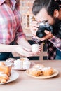 Food photographer man assistant cakes pastries Royalty Free Stock Photo