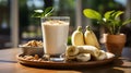 Healthy banana smoothie milkshake in glass with bananas on table