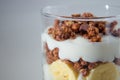 Food photography of a banana parfait with chocolate granola.