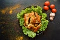 Food photography. Chicken wings with lettuce on a black background. Appetizing grilled meat, barbecue. Tasty dinner. Chicken wings