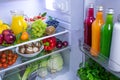 Food photography of a clean fridge filled with vegan foods such as fruits vegetables, juices and plant milk Royalty Free Stock Photo