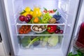 Food photography of a clean fridge filled with vegan foods such as fruits vegetables, juices and plant milk Royalty Free Stock Photo