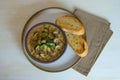 Food photography of a creamy mixed mushroom soup with herbs and toasted bread on a white surface Royalty Free Stock Photo