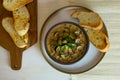 Food photography of a creamy mixed mushroom soup with herbs and toasted bread on a white surface Royalty Free Stock Photo