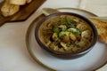 Food photography of a creamy mixed mushroom soup with herbs and toasted bread on a white surface Royalty Free Stock Photo