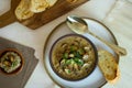 Food photography of a creamy mixed mushroom soup with herbs and toasted bread on a white surface Royalty Free Stock Photo