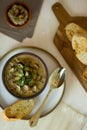 Food photography of a creamy mixed mushroom soup with herbs and toasted bread on a white surface Royalty Free Stock Photo