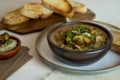 Food photography of a creamy mixed mushroom soup with herbs and toasted bread on a white surface Royalty Free Stock Photo