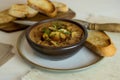 Food photography of a creamy mixed mushroom soup with herbs and toasted bread on a white surface Royalty Free Stock Photo