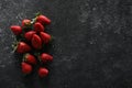 Food photography. Delicious ripe strawberries on black textured table, flat lay with space for text