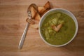 Food photography image of home made broccoli pea potato soup in white bowl with love heart shape toast on rustic wood background Royalty Free Stock Photo